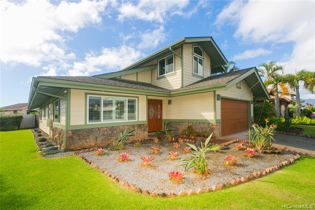 A Former model home  Pacific Traditions Manoa Model with numerous upgrades and customizations. This lovely 3 bedroom 2 and a half bath home has been upgraded with both custom front entry and garage door.  Double pane windows, shutters for privacy, easy care engineered bamboo flooring throughout most of the home. This home is in move-in condition with a central A/C system, newer kitchen appliances, a new dishwasher, a beautiful quartz countertop, and a breakfast bar. Built-in bookshelves in the living room. Master suite with a built-in window seating area (more shutters) and spacious walk-in closet. The master bath has a glass shower stall and a full-sized soaking tub. Landscaped yard with sprinkler system and HUGE  backyard covered lanai wi
