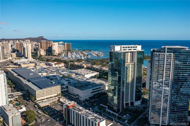 RARE JEWEL!!! The only 1 bdrm/1 bath unit in the stunning Hawaiki Tower-featuring travertine & hardwood floors, new living room ceiling fans & Nest thermostat to keep cool while you live & work at your best.
BREATHTAKING serene ocean & city views with a great floor plan, walk-in closet, granite & marble countertops and thermal tinted windows. Open kitchen equipped with a new microwave, Gaggenau appliances & 2021 smart ss Sub-Zero refrigerator. Recent upgrades include bath & kitchen faucets and supply lines.
Pristine building with low maintenance fees, local artwork throughout, resort-like amenities with surfboard & bike storage, meeting room & guest parking.  Grow organic in the community garden while fur babies enjoy generous grassy grou
