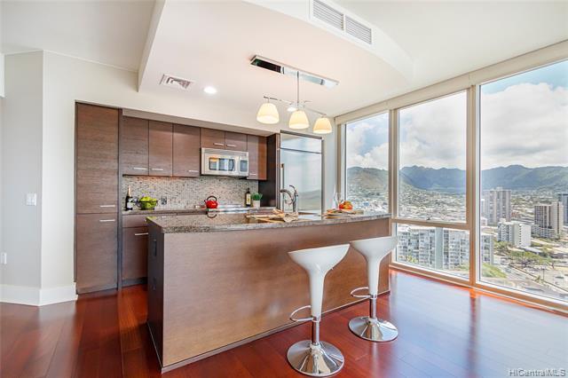 BEAUTIFUL AND GORGEOUS 2Bed/2Bath unit w/1 car parking at the entrance of Waikiki! Conveniently located near Ala Moana Shopping Center, beaches, bus line, restaurants and freeway access. NEW kitchen APPLIANCES, NEW HARDWOOD flooring, NEW carpets, window shades & NEW water heater! COVETED CORNER unit with SPECTACULAR OCEAN & MOUNTAIN views from the LARGE LANAI. Amenities include pool, jacuzzi, BBQ, recreation room, bike rack, surf rack, dog park, lobby fire pit, private garden, 24-hour concierge, pet friendly & guest parking.