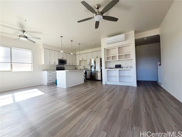 Spacious living & dining room & kitchen with stainless steel appliances.