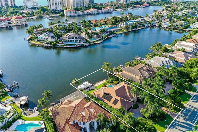 Luxury WATERFRONT living awaits you in beautifully appointed custom home in the heart of Naples. The