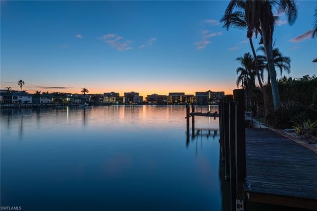 Enjoy coveted south-facing bay views from this beautiful waterfront homesite in the Moorings. Situat