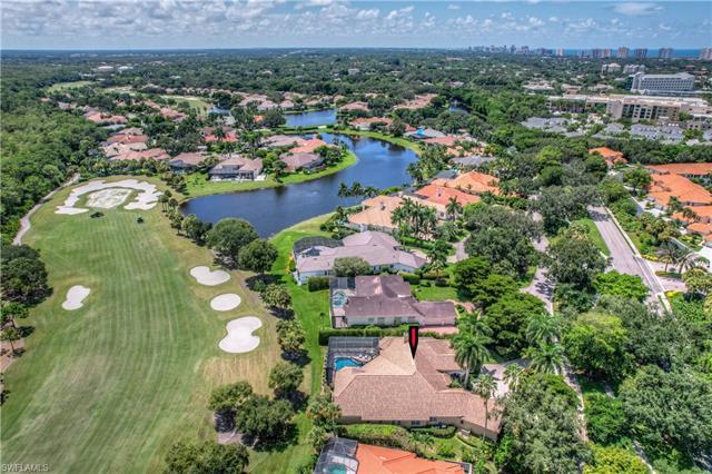 Spectacular family home in the multi-gated golf course community of Pelican Marsh, on a large lot wi