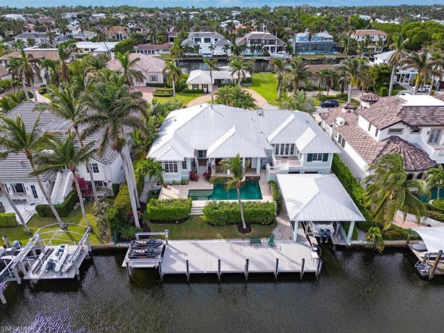 Falconer Jones designed custom built home on wide water canal. Includes a covered boat house with li