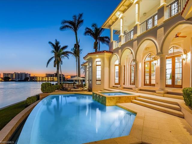 Immerse yourself in the privacy, space, and elegance of this luxurious Naples estate that commands s