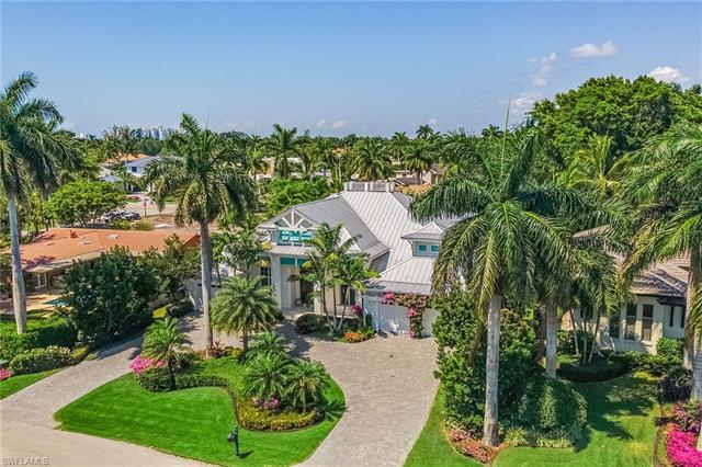 This West of Crayton Road custom home is a private oasis perfectly located in the heart of Naples. N