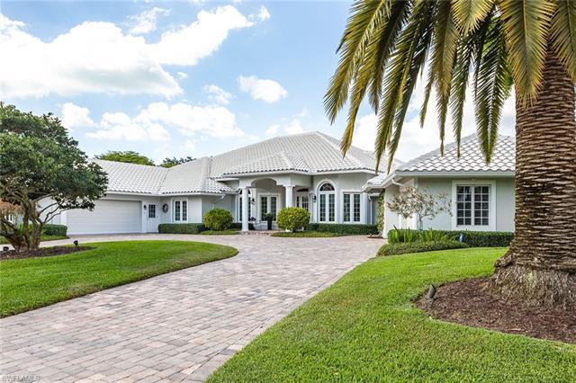 Classical elegance in Pelican Bay. This spacious single-story home has been artfully expanded and re