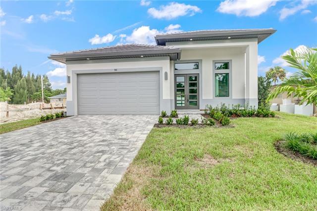 This is your chance to own a custom-designed luxury home newly built in the desirable Naples Park an