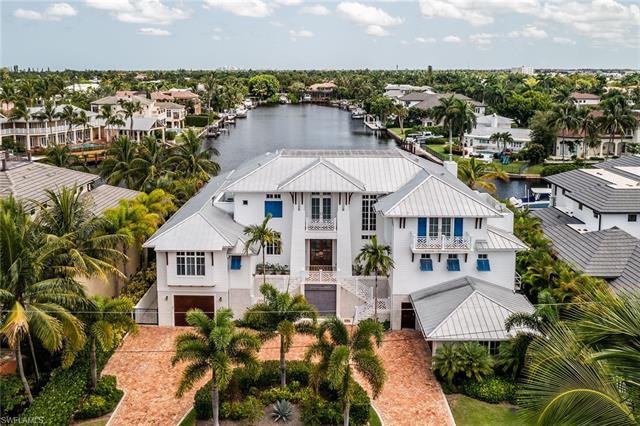 BOATERS AND CAR COLLECTORS DREAM. Nestled along the widest canal in Aqualane Shores, this 6,000-sq. 