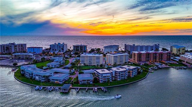 Nestled between Venetian Bay and the Gulf of Mexico, this top-floor haven at Harborside West is a tr