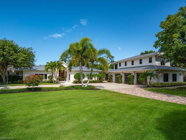 Set on 1.36 lush, private acres in Pine Ridge Estates, this remarkable residence stands ready to mak