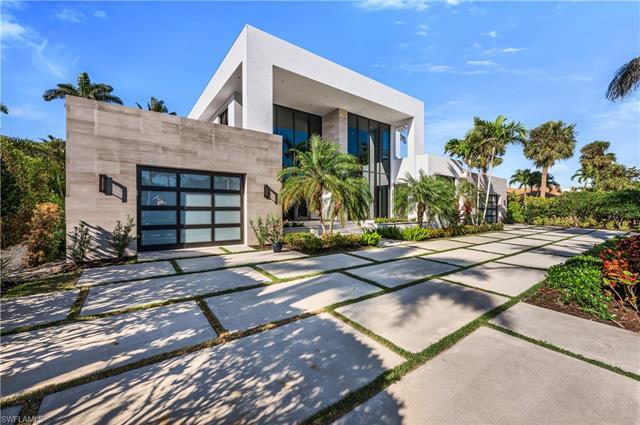 Welcome to 665 Fountainhead Way, a modern tropical masterpiece created by Joel Barnes Homes. Built i