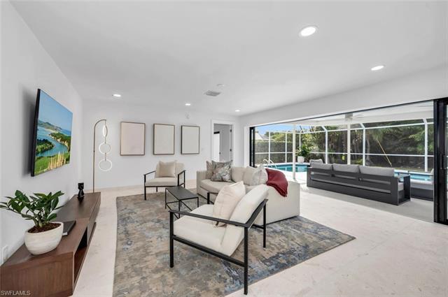 Nestled in the heart of Park Shore, this stunning residence sits on an oversized corner lot, surroun