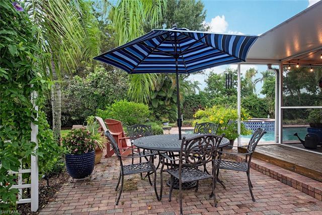 H12135. In The Moorings, this charming one-story residence, updated over time, sits on a lushly land