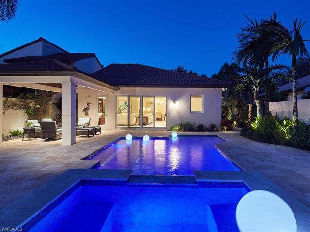 Lush, private, extensively remastered southern exposure Las Brisas villa in the heart of Pelican Bay