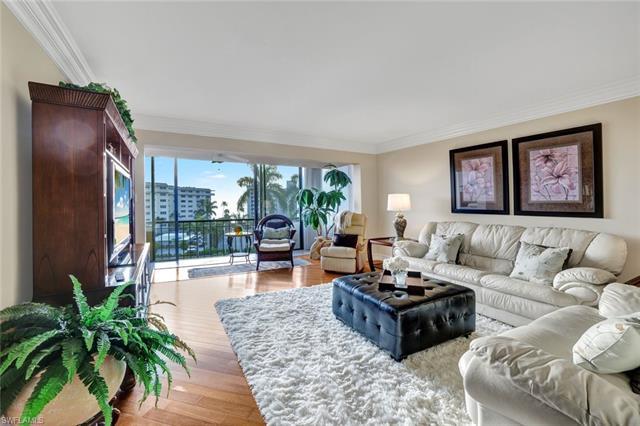 Located a mere 250 steps from the pristine Naples beach, this updated and stunning unit in the exclu