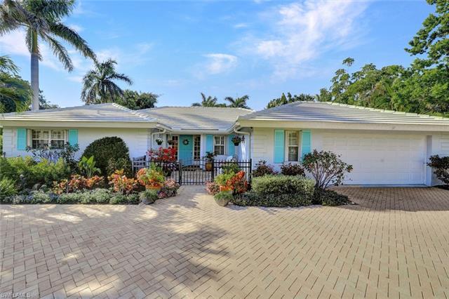 This beach bungalow is located in the sought after West of 41 Park Shore neighborhood. This quintessential 3 bedroom 3 bathroom renovated pool home sits on a .34 acre lot that is well manicured and enjoys ultimate privacy.  As you enter this inviting 2700+ square foot home, you will appreciate the updates throughout (wood plank tile flooring, plantation shutters, white cabinetry) and you will love the natural light that emanates through the wall-to-wall sliding glass doors that overlook the heated pool, screened lanai & tropical, private backyard. Relax the day away lounging by the pool, enjoy a soak in the outdoor 2 person hot tub, sit in the front courtyard or get your hands dirty in the garden. This home features a traditional “old Florida” floor plan, with a living room, dining room, family room and a Florida sunroom.  The home revolves around the drawer design kitchen with marble countertops, white wood cabinetry, SS appliances and plenty of storage. The oversized primary suite features a raised tray ceiling and sliding doors to the pool area.  The renovated primary bathroom has a freestanding tub overlooking an orchid garden, a walk in shower, double sinks, a make up area and a large walk in closet and dressing area.
Guests will enjoy their privacy with two guest bedrooms, each with a dedicated full bathroom. For peace of mind, storm protection includes accordion shutters, fixed shutters, a roll down shutter at the front door and a 20kw Cummins generator w/ a dedicated
