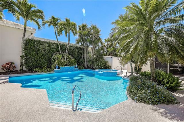Stunning courtyard home overlooking golf course with lush tropical landscape  Exterior spacious cour