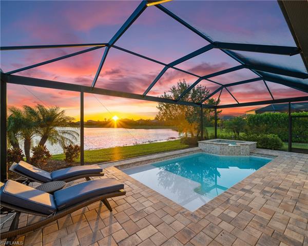 Stunning sunset views from this premier lot luxury home in Naples Reserve!  Located on a lake facing