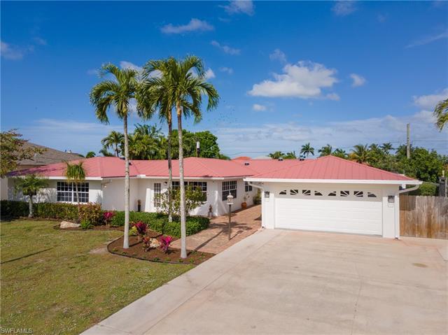 Rarely available, this expansive ranch-style home in Naples Park sits on a coveted double-lot just t