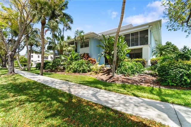Charming Downtown Old Naples Location! This first-floor corner end unit is flooded with natural ligh