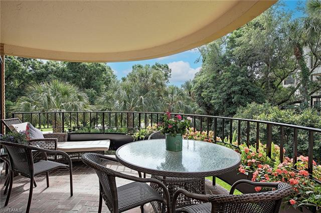 Enjoy views of the Pelican Bay golf course from two wrap-around balconies with wrought iron railings