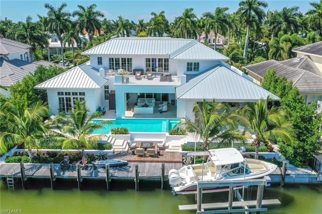 Magnificent 5BR/6.5BA + Den two-story turnkey furnished pool and spa home with boat dock in Aqualane