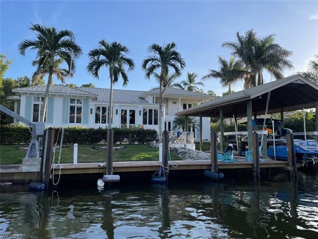 LOCATION, LOCATION, LOCATION, This Aqualane Shores, waterfront home is only seconds to Naples Bay an