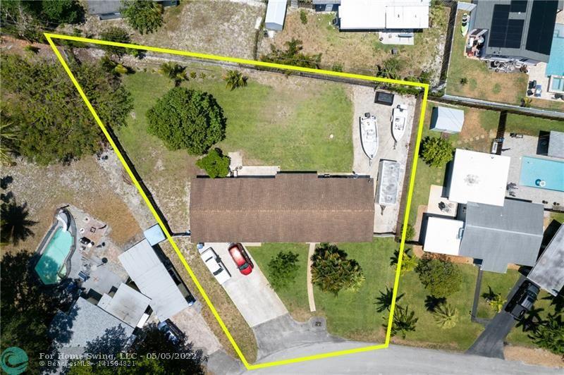Solid house sits on a giant lot of 14,157sf in Central Wilton Manors --- lots of potential here!!  House has 3 beds, 2 baths, plus a family room, large laundry room, with all impact windows and doors installed 2021.  Whole house was re-stuccoed in 2021 as well.  New A/C system in 2018.  OVERSIZED 2 car garage (doors not impact).  RV / Boat pad with drain line, electric service and hook up on the east side of the house, behind a fence.  So many OPTIONS:   renovate the interior; renovate and add a whole wing onto the house;  tear down;  add a pool;  add a tennis / pickle ball court -- or both!!  Lots of redevelopment and new construction all around.  Sellers request a closing after July 22, 2022.