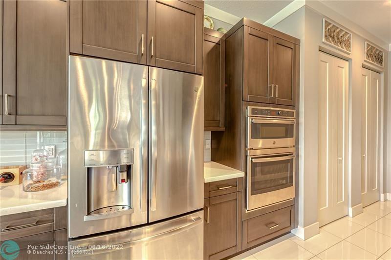 Refrigerator with Keurig machine on door and wall oven and microwave