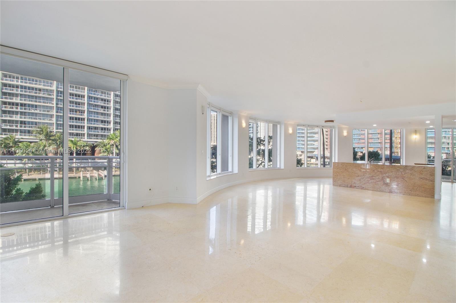 Live on top of the Biscayne Bay and Miami River in this spacious corner unit which feels like a home