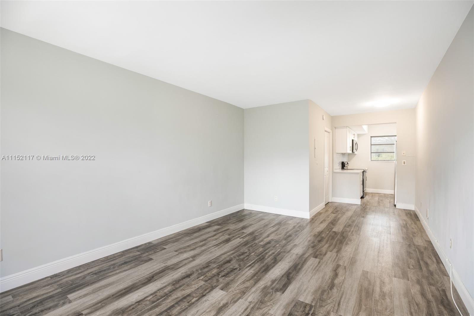 Updated studio apartment featuring large windows, a spacious walk-in closet, and laundry facility in