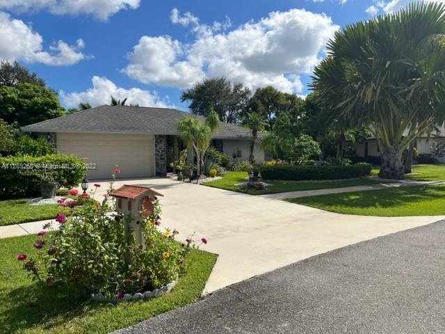 Beautifully landscaped lot front and back with fenced pool and screened lanai with wet bar. Back als