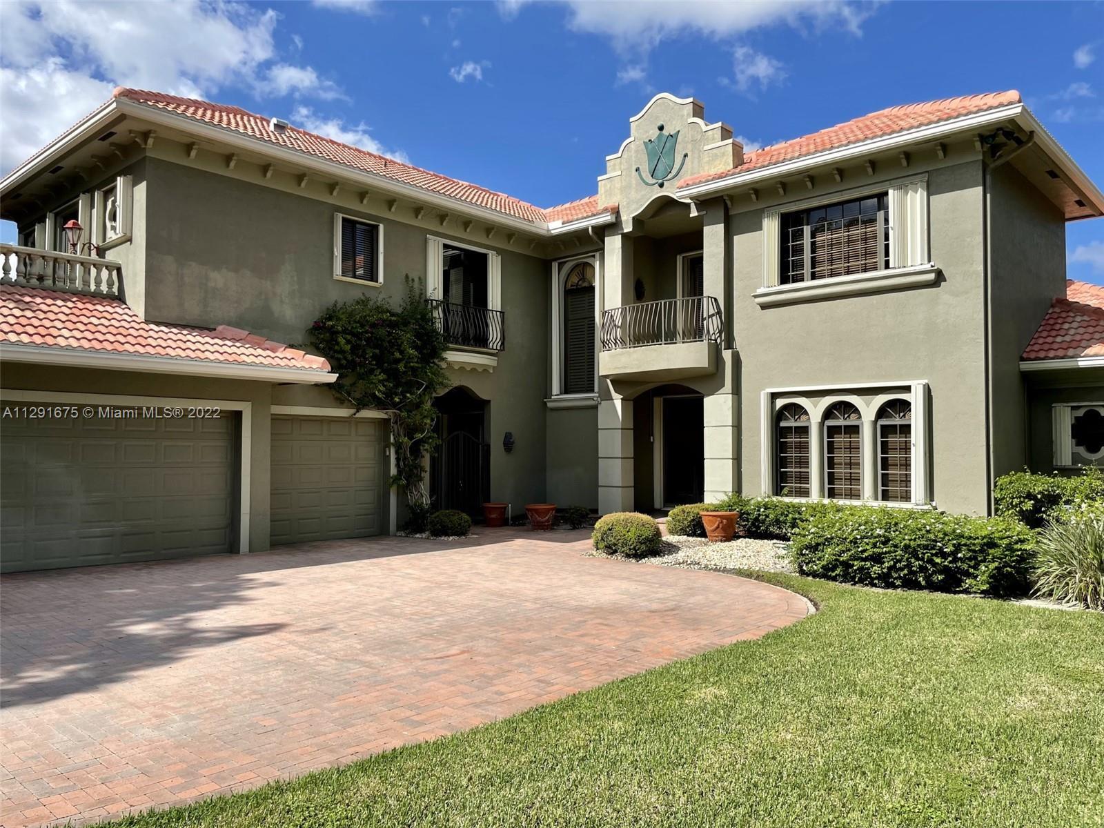 Estate home located in the Chateau section of Boca Grove. Oversized lot with magnificent lake and go