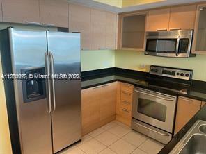 Bright, spacious and tastefully remodeled 2/2 split floor plan condo featuring high ceilings, wood f