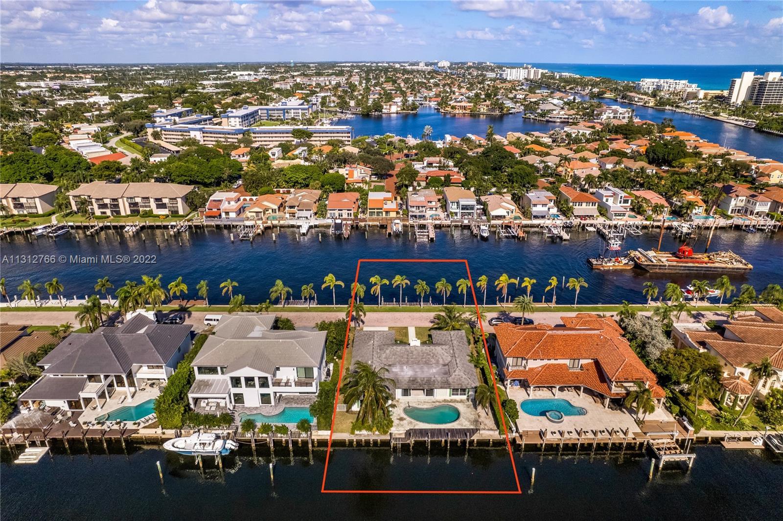 Very rare and private DOUBLE WATER-FRONT HOME on one of the most exclusive streets in the Boca/Delra