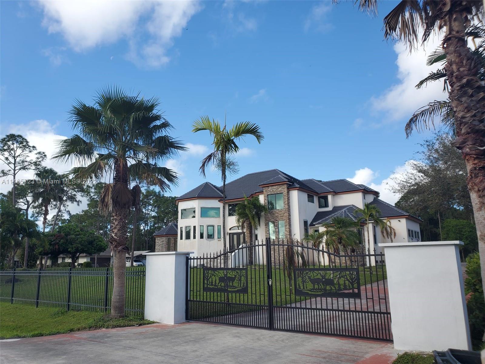 Renovations Complete! Stunning estate home in Jupiter Farms. This extensively renovated, 5300 sq. ft