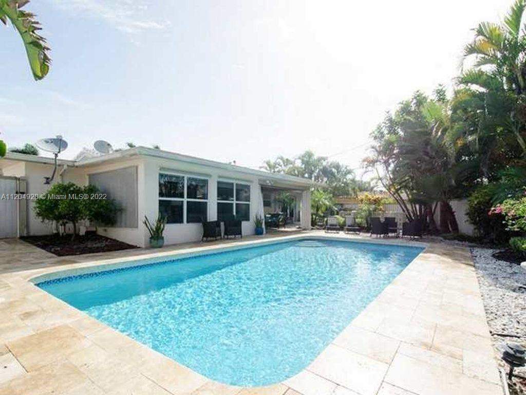 East side Fort Lauderdale Oasis Home with 3 Bed/2 Bath and salt water pool. Lush Tropical Landscapin