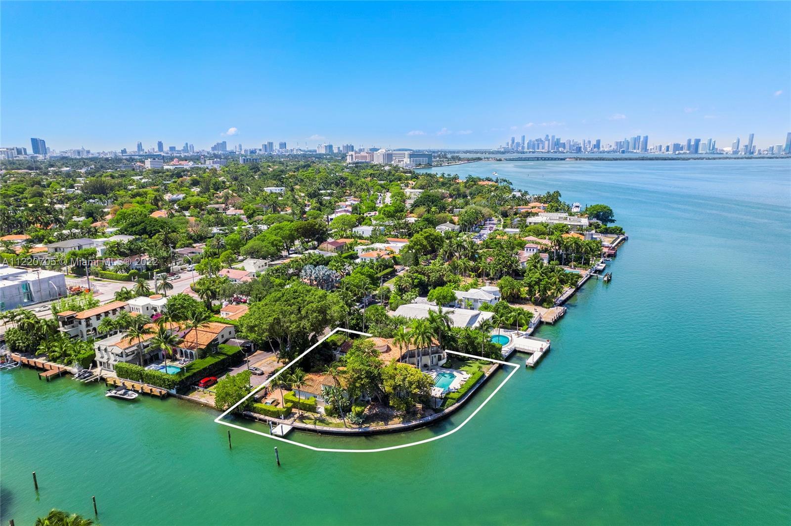 Located on prestigious North Bay Road this 2-story Mediterranean waterfront home sits on a private 2