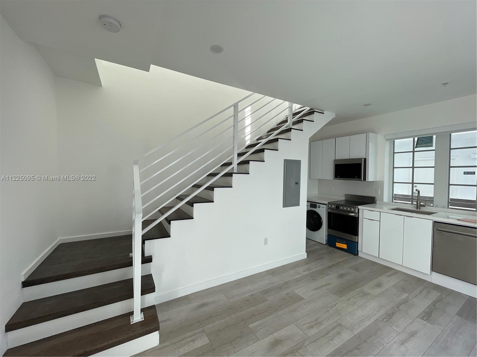 Chic and modern brand new 2 story home in a completely renovated Art Deco condo conversion. This lov