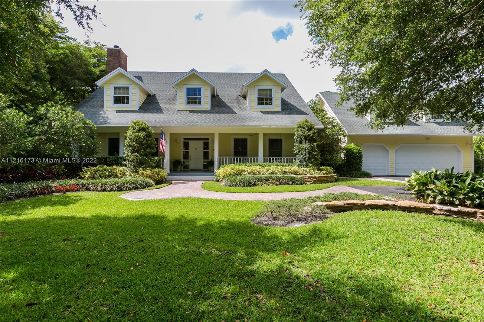 Beautiful two-story key west style home nestled on an acre with fantastic curb appeal!  The main hom