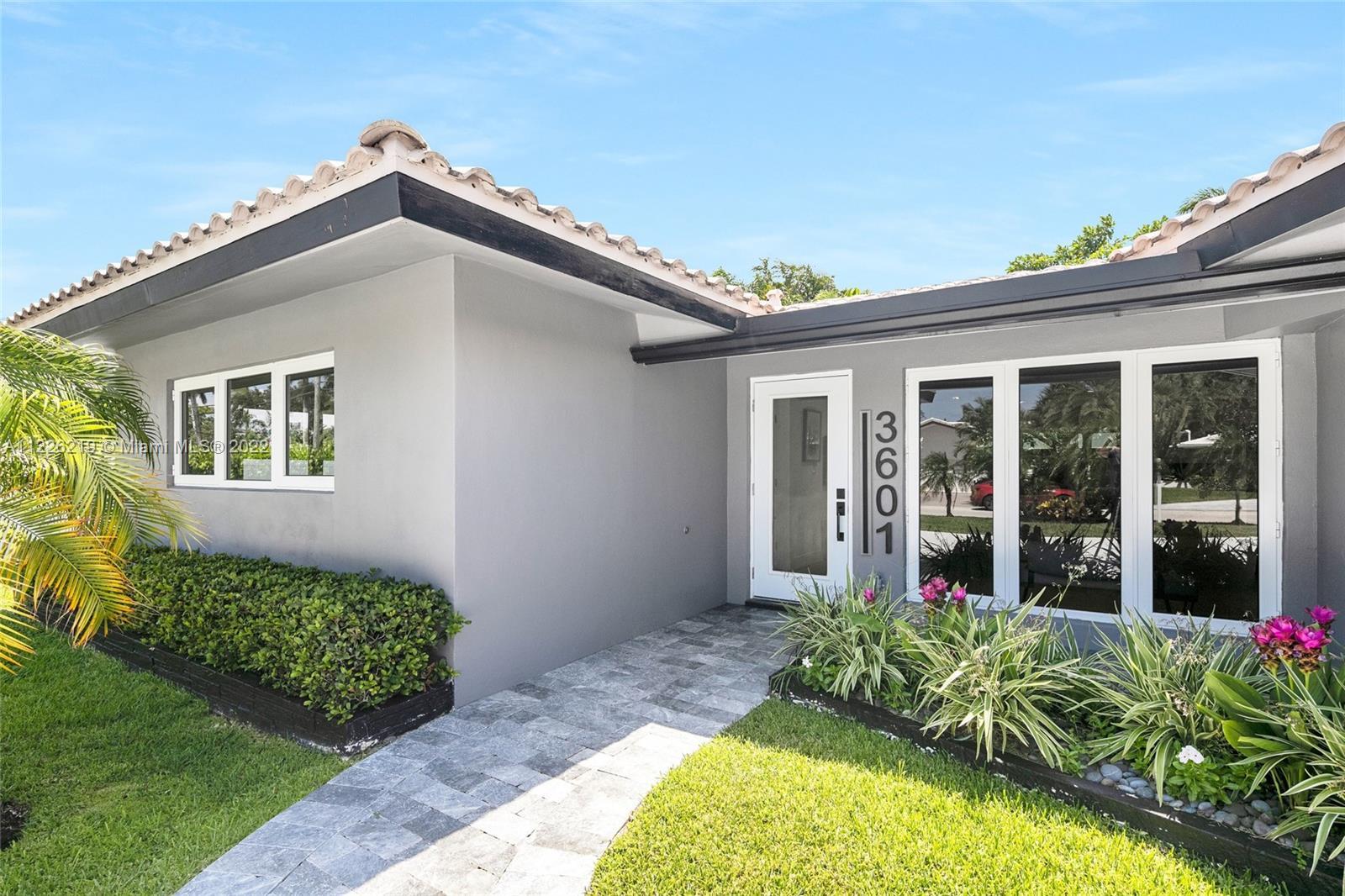 Stunning renovation in coveted Coral Ridge Country Club. Located on a private, 9,866 square foot cor