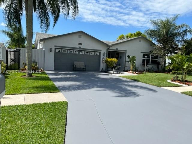 Beautiful house in West boca featuring upgrades to the kitchen, bathrooms, flooring. Outdoor grill a