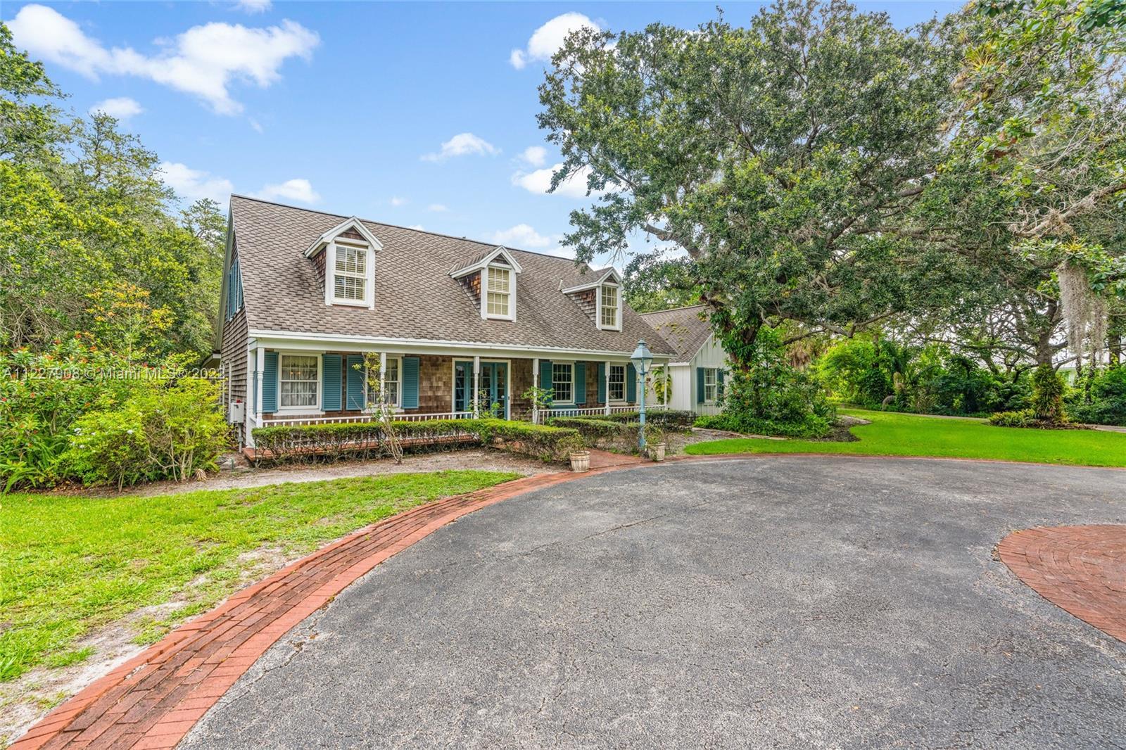 2.5 Acres in the heart of Jupiter. This home boasts wood beams and flooring, sitting room, office, d