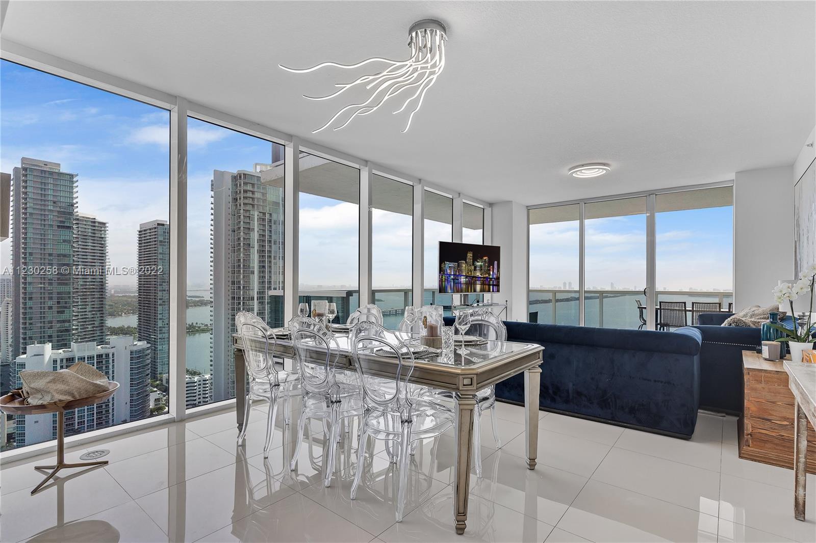 Live in style at this modern custom residence at Bay House in Edgewater. This corner unit has breath