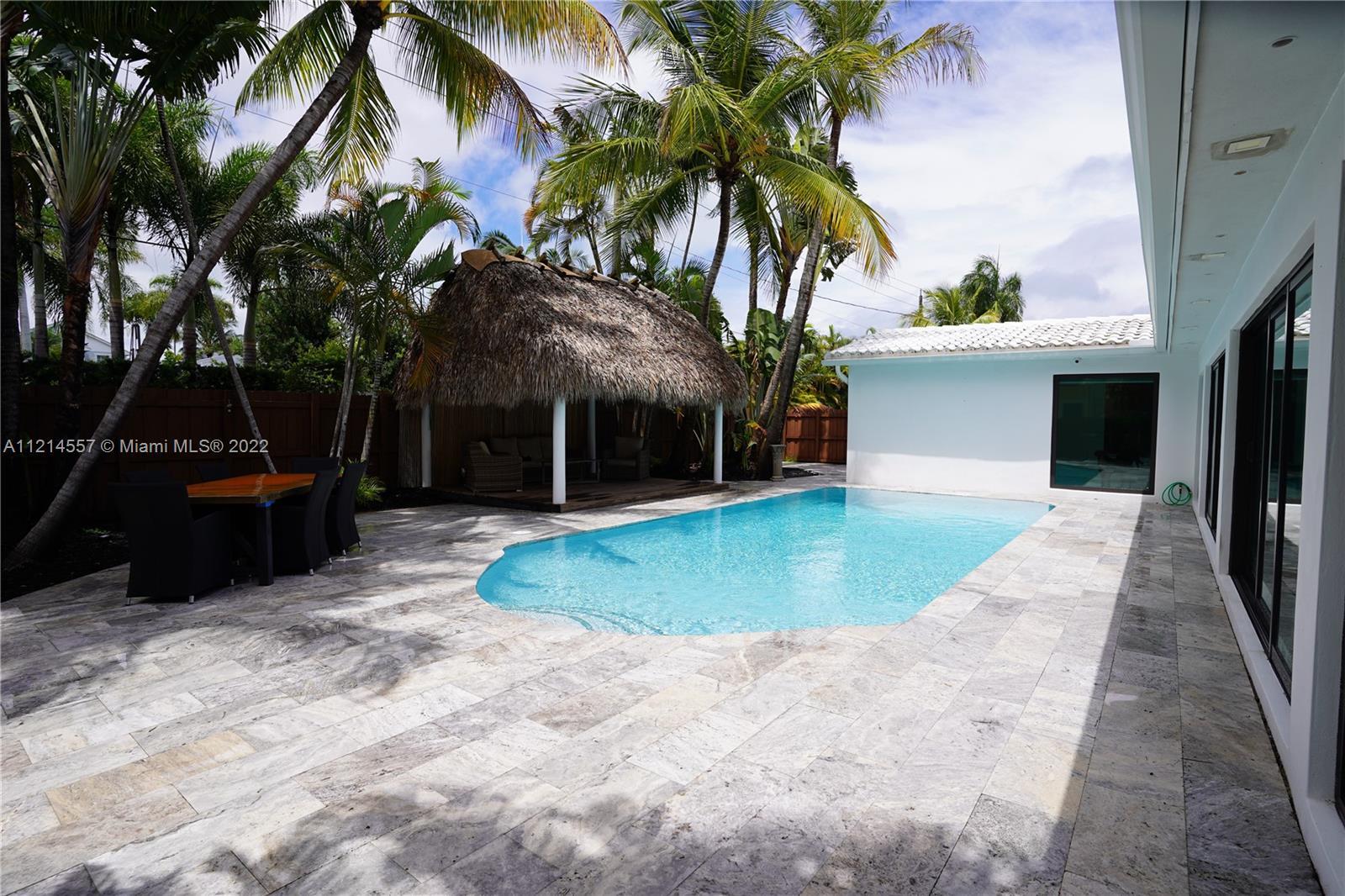 Enjoy your tropical lifestyle in this luxurious, turnkey 4 Bd/3 Bath, 2 car garage home! Contemporar
