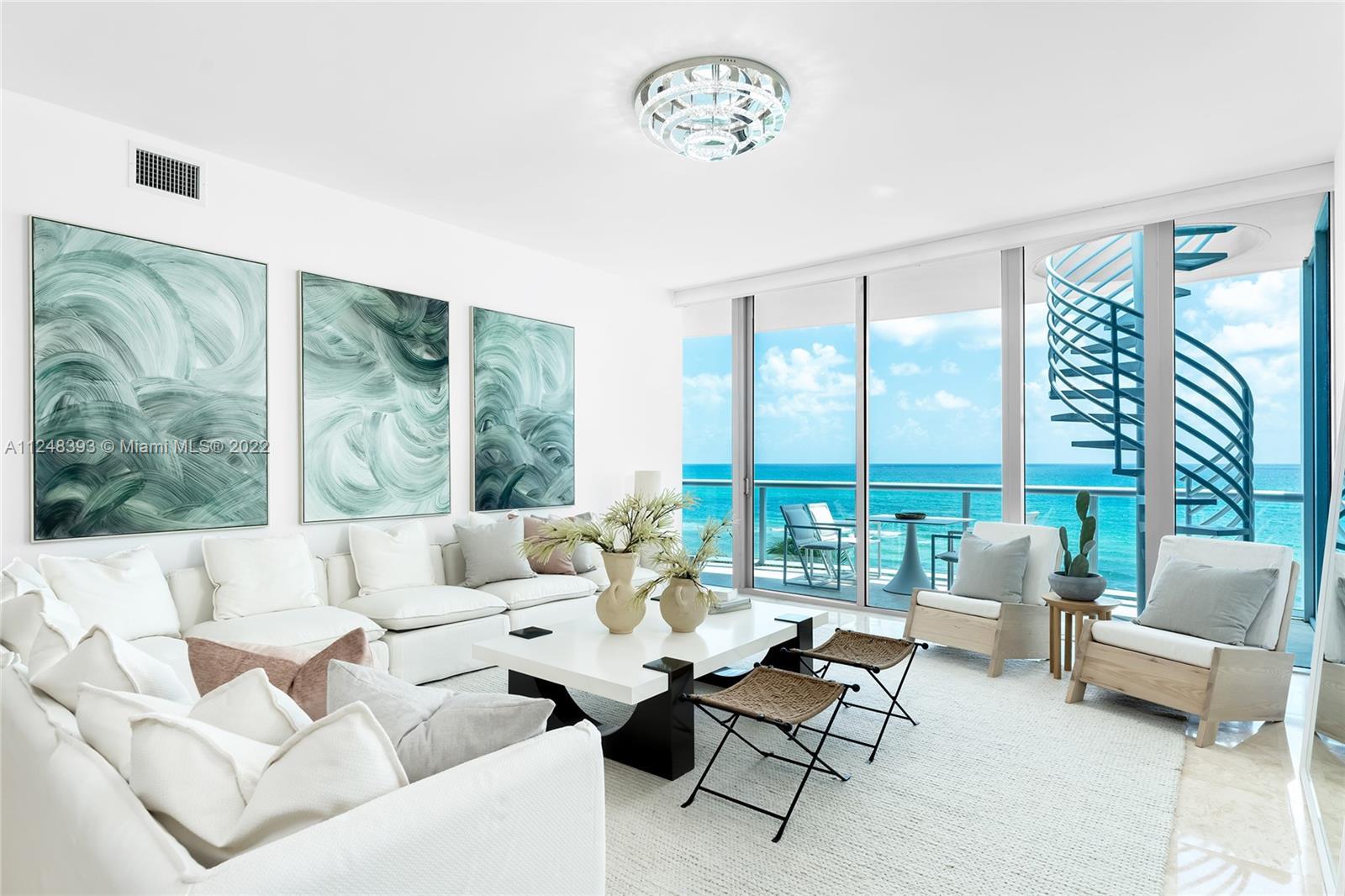 This direct oceanfront Northeast corner penthouse at the Carillon Condo in Miami Beach features a 83