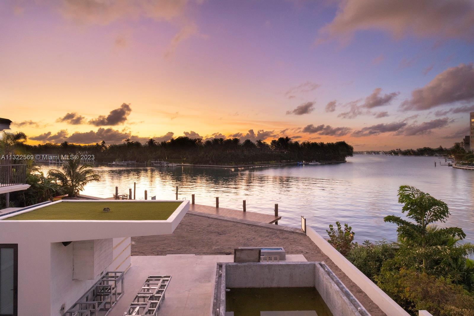 Extraordinary new luxurious villa in exclusive Surfside. Modern tropical design with 25 ft waterfall