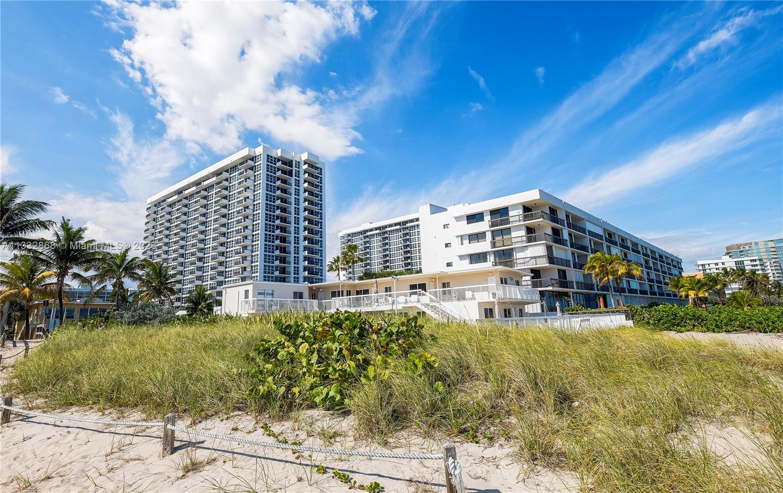 Stunning condo-townhouse just steps away from the beach. This corner unit offers the best of both wo