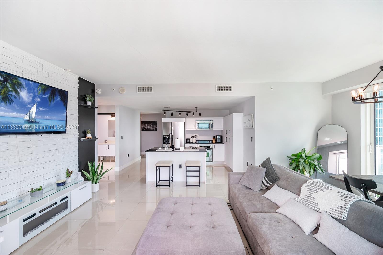 This corner unit located in Quantum on the Bay features two bedrooms and two bathrooms with a wrapar